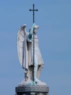 statue of the archangel michael with a cross