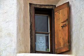 old wood Window on white stone wall