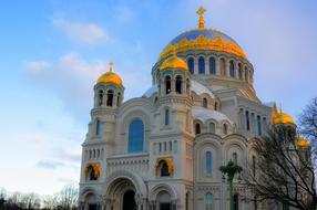 golden domes of naval cathedral at winter evening, russia, st petersburg, kronstadt