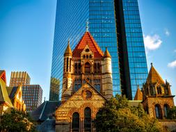 Historical building of trinity church in front of skyscraper with windows, USA, Massachusetts, Boston