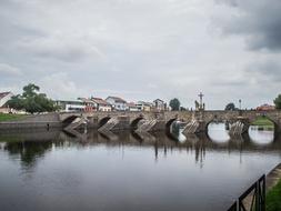 cloudy sky over the stone bridge over the river