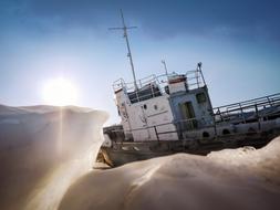 Fishing vessel near the ice in Siberia in light