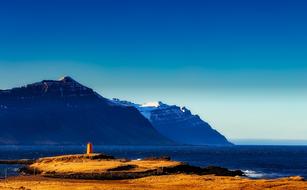 Beautiful mountains in snow on the shore in Iceland