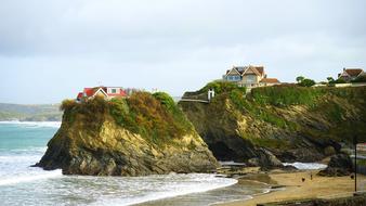 Colorful houses on the colorful and beautiful cliffs on the shore with sand