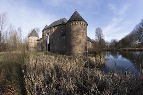 Castle with Towers on waterside at winter, germany