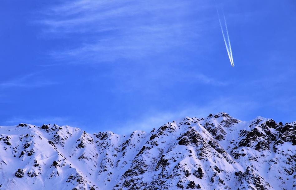 blue sky over snow-capped alpine mountains