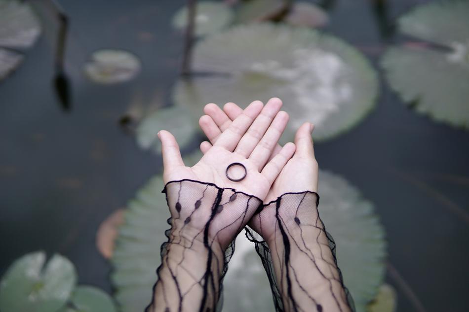 ring in hand over the pond