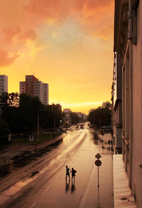 people on the street in the rain in the city of ostrava