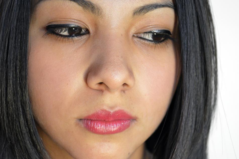 Portrait of the woman with makeup looking down on white background