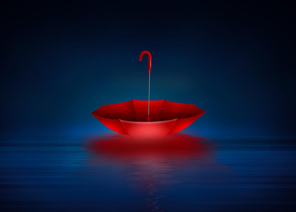 Beautiful, red umbrella upside down on the blue water among the darkness