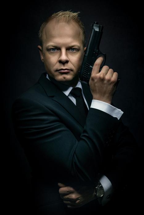 man in suit with pistol