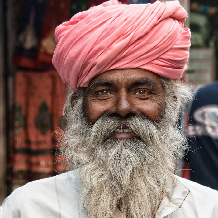 Portrait of the smiling Hindu man with white beard in India
