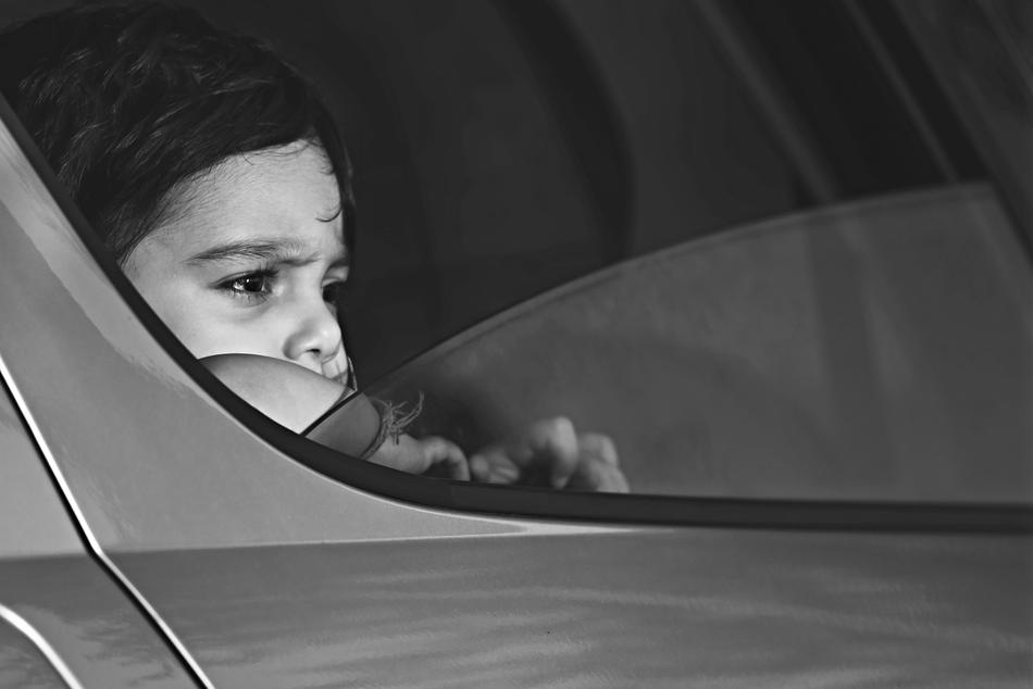 little girl in the car window in black and white background