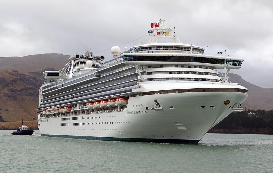 'Diamond Princess' cruise sheep on the water, near the colorful and beautiful shore with the hills, under the cloudy sky