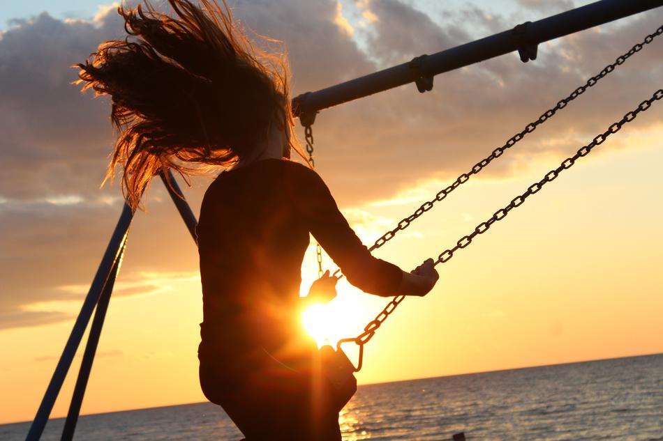 Girl on swing at Sunlight Sunset