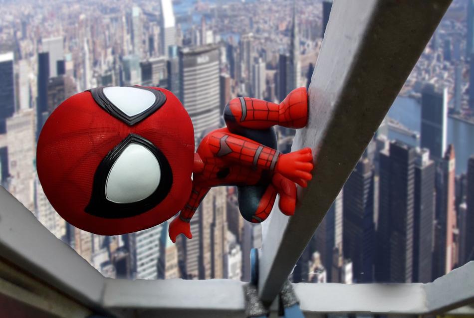 Spiderman, toy on bar above skyscrapers