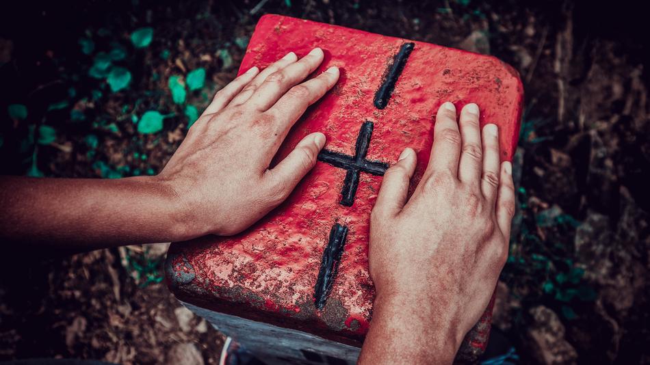 closeup view of Hands on red book