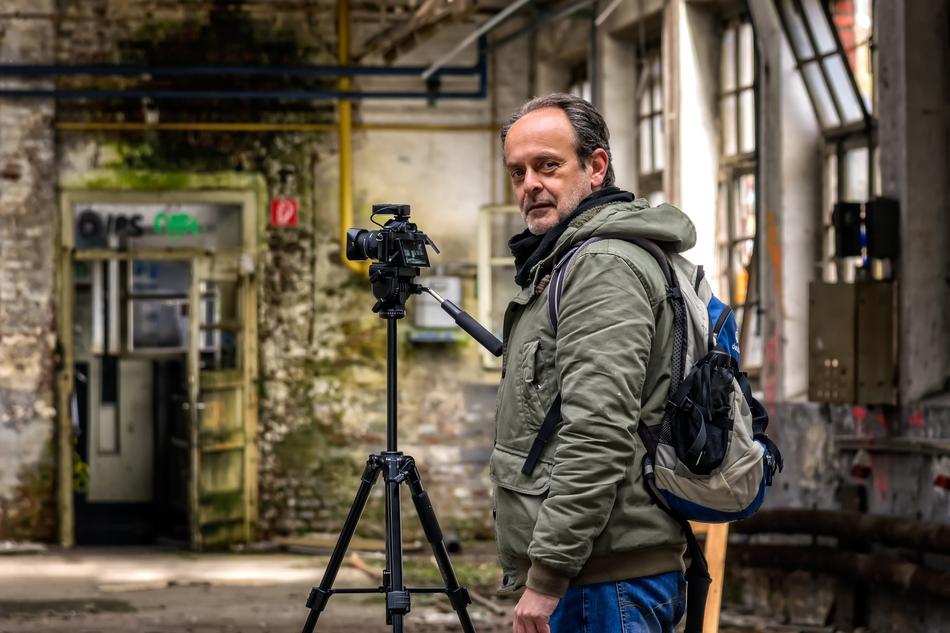 photographer with a camera in an abandoned place