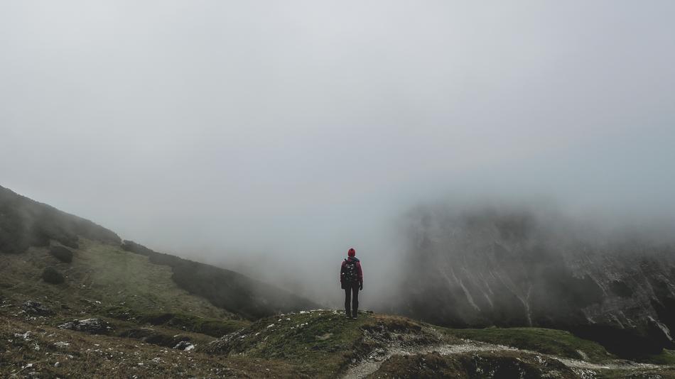 man on the mountain during the fog