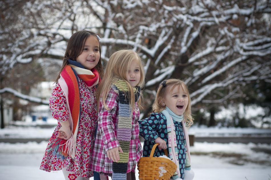 photo of three young girls in the winter garden