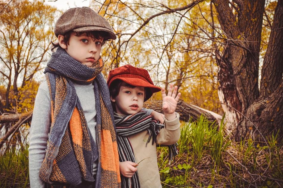 Brothers kids among the colorful and beautiful plants in the autumn