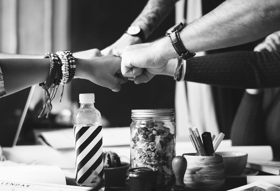 fists of adults over the table in black and white background