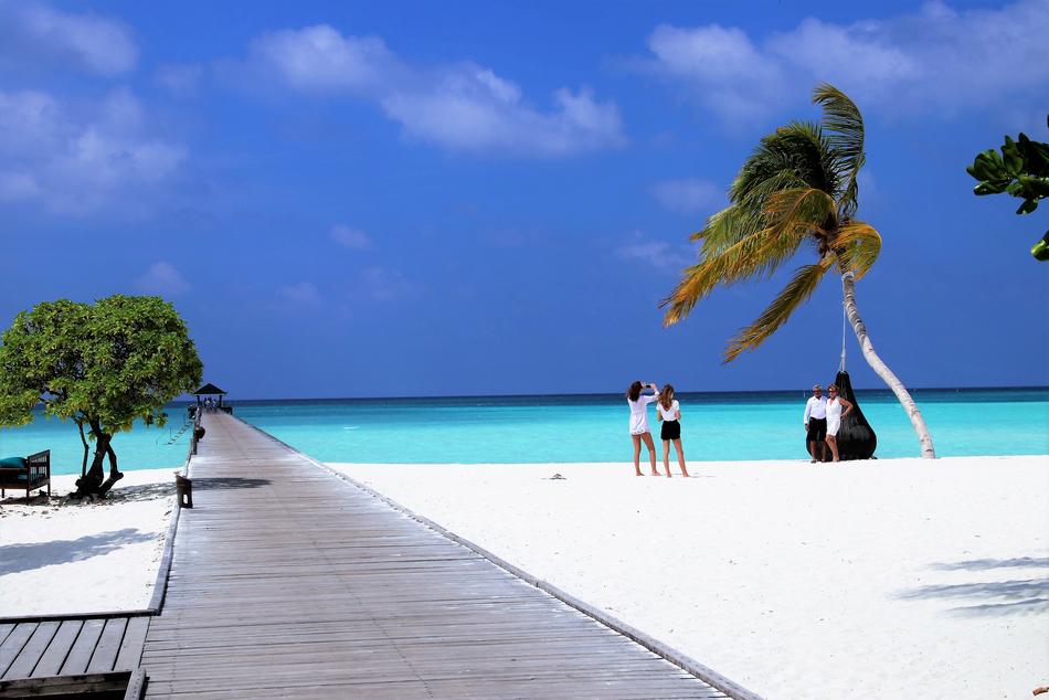 people on the beach in the maldives