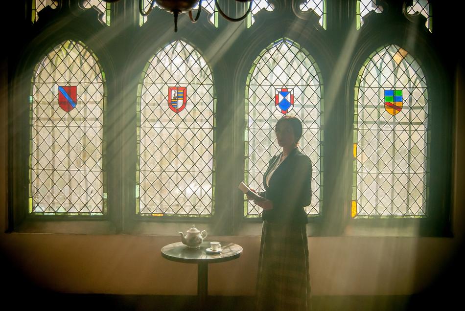 woman with book in the game of shadows in the ancient room