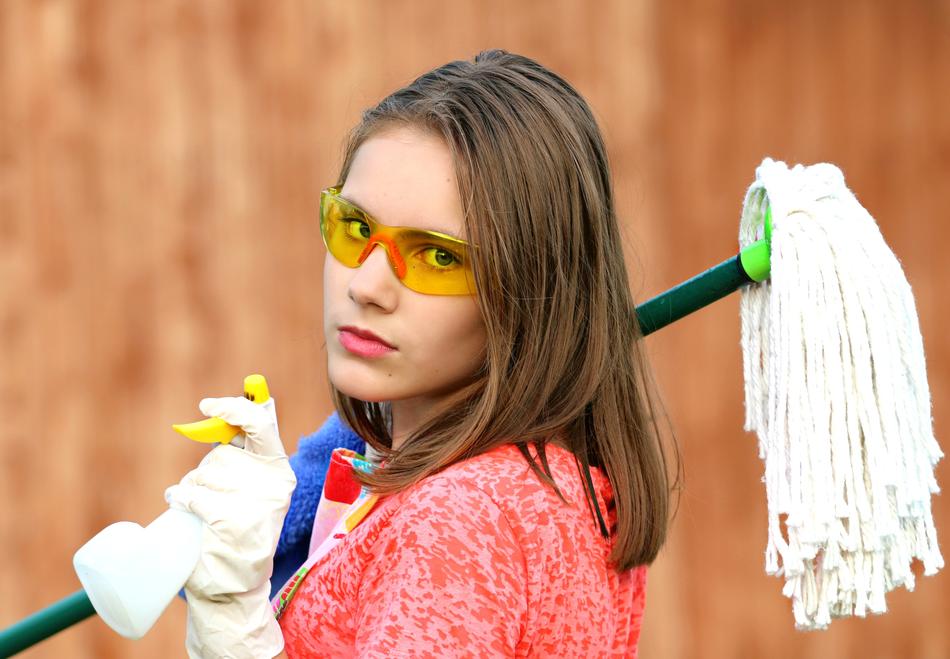 young girl with a mop in goggles on a blurred background