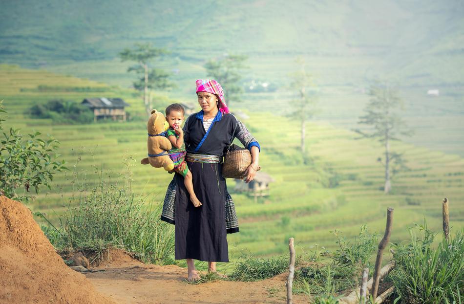Mather with the daughter, with the cute Teddy Bear, near the beautiful and colorful fields in Bali, Indonesia