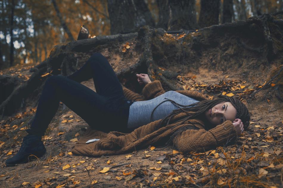 beautiful girl on a photo shoot in the forest at dusk