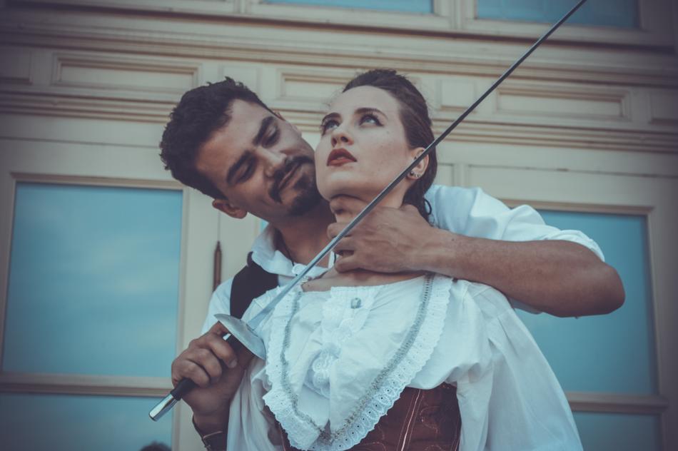 a man threatens a girl with a sword