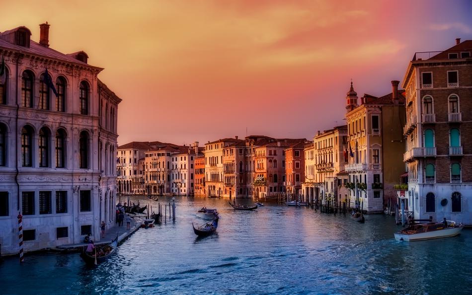 Boats on the beautiful canal, among the colorful houses, at colorful sunset, in Venice, italy