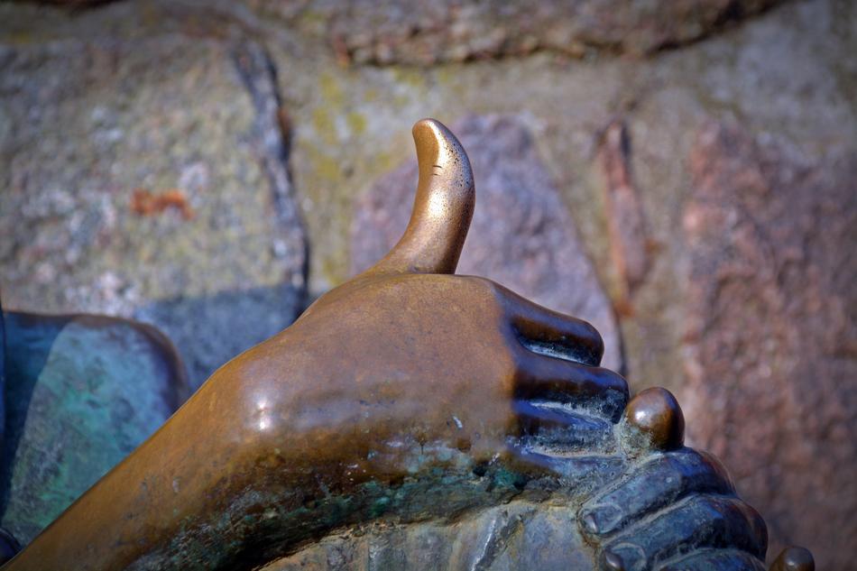 Close-up of the shiny hand of the statue of Till Eulenspiegel, in MÃ¶lln, Germany