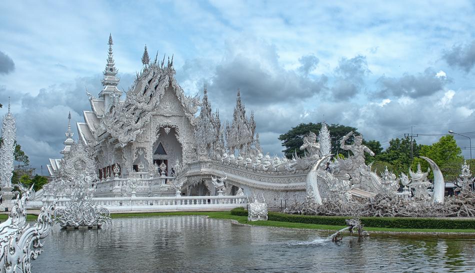 white temple near a lake in Thailand
