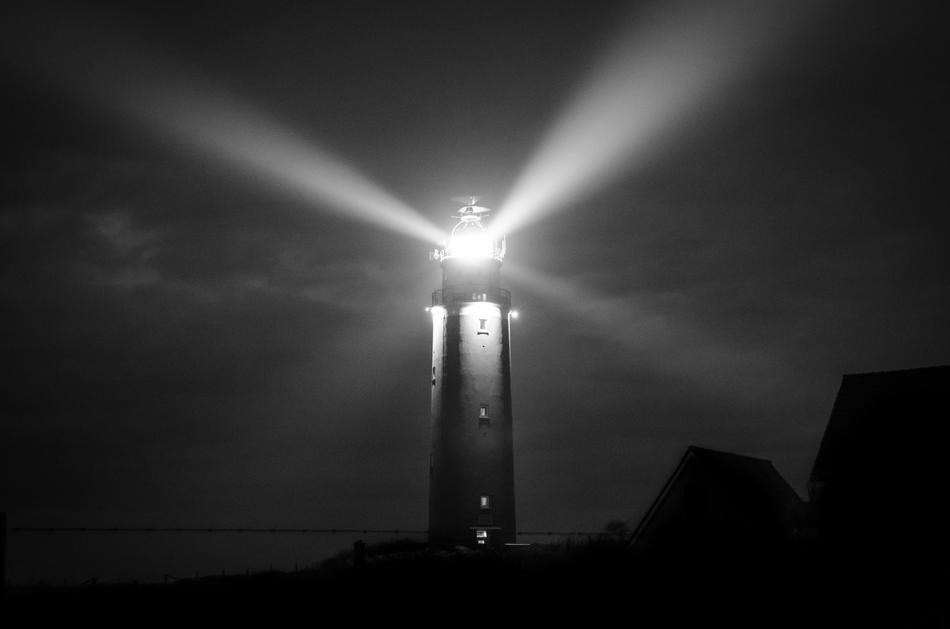Lighthouse over Sea at Night
