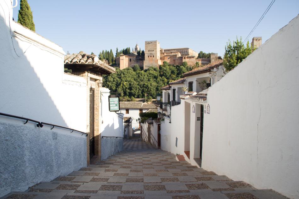 narrow street along the white walls in Granada
