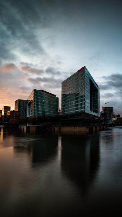 Beautiful buildings on the shore in Hamburg, at colorful sunset, in Germany