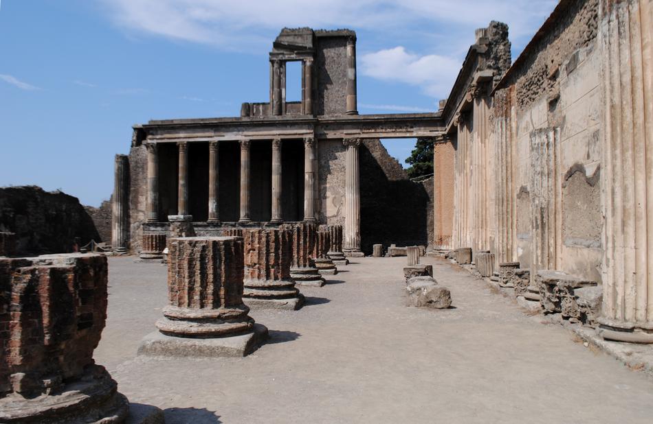 Beautiful, old building with the columns, in Pompeii, Italy, at blue sky with white clouds on background