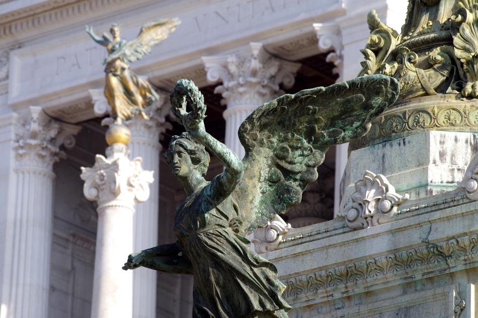 sculpture with a laurel wreath in front of a building in rome