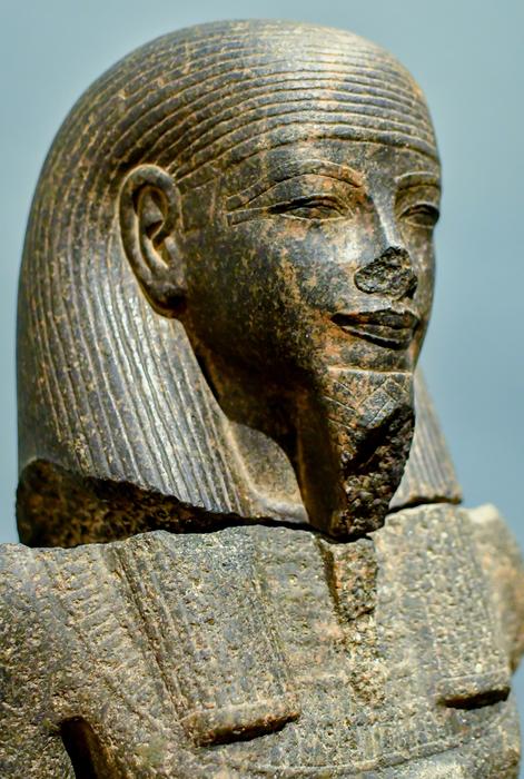Beautiful Egyptian Pharaoh statue at blue sky background