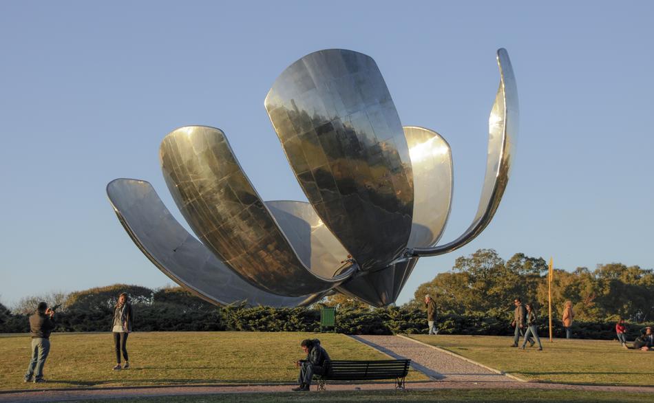 People, near the shiny monument in Buenos Aires, Argentina, among the colorful trees