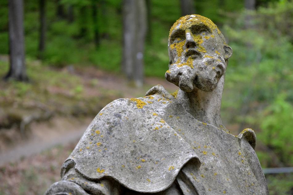 moss on a statue in the park on a blurred background