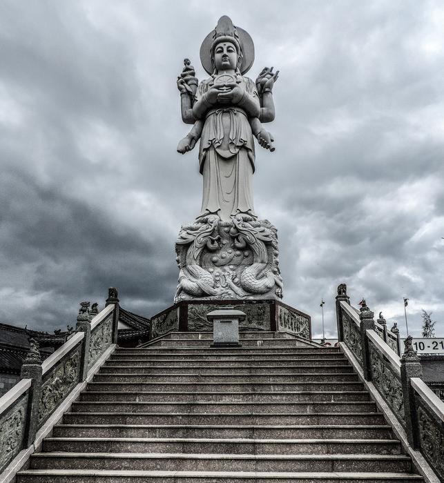Beautiful sculpture of the Goddess, with the steps, under the cloudy sky