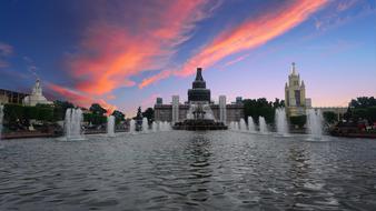 red sunset sky over fountain complexes