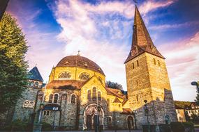 Beautiful church, among the colorful trees in Balve, Germany, under the blue sky with colorful clouds