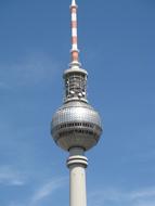 the top of the TV tower against the blue sky in berlin