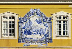 ceramic ornament on the wall near white windows