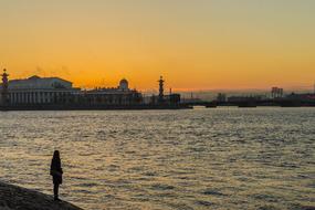evening photo of a girl on the embankment of the Peter and Paul Fortress in St. Petersburg