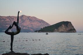 Monument of yoga poser on Sea coast